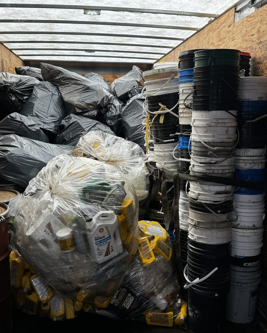 Bulk bins of used paint and oil pails at the Grey is Green yard waiting to be processed into plastic lumber