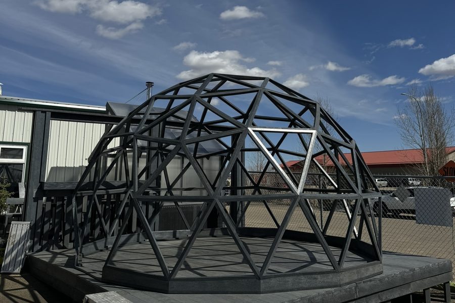 A geodesic dome frame standing on a recycled plastic lumber platform