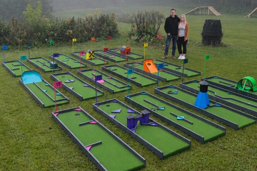 A portable mini-golf course built on recycled plastic lumber, laid out on grass