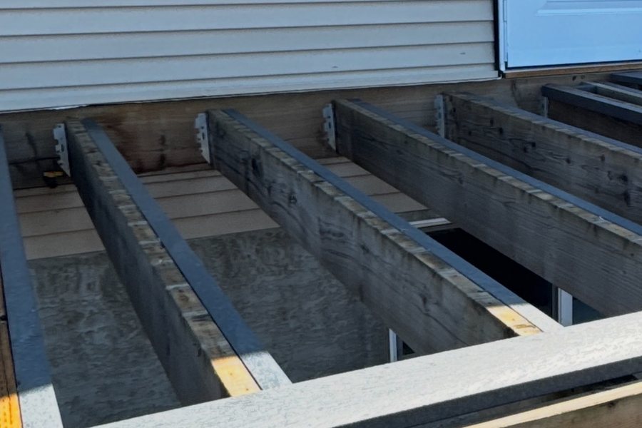 Joists with the first recycled plastic deck boards being laid
