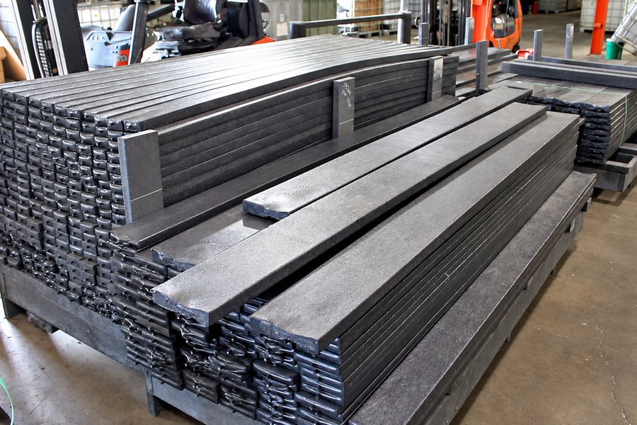 Stacks of finished recycled plastic lumber boards on the plant floor